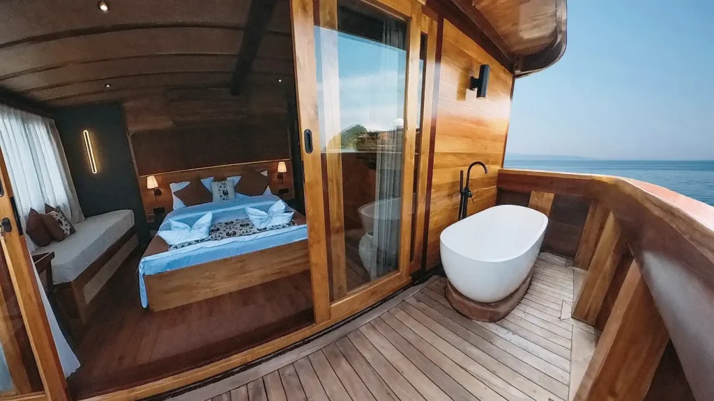 The shaded deck lounge of a phinisi at anchor