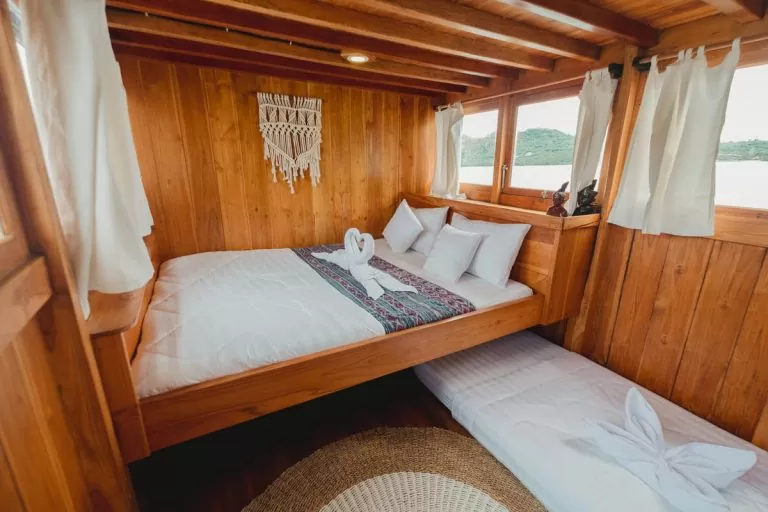 The shaded deck lounge of a phinisi at anchor